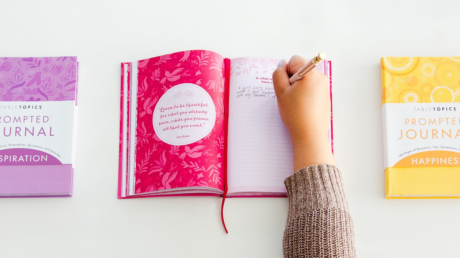 Writing in a prompted journals showing how to journal