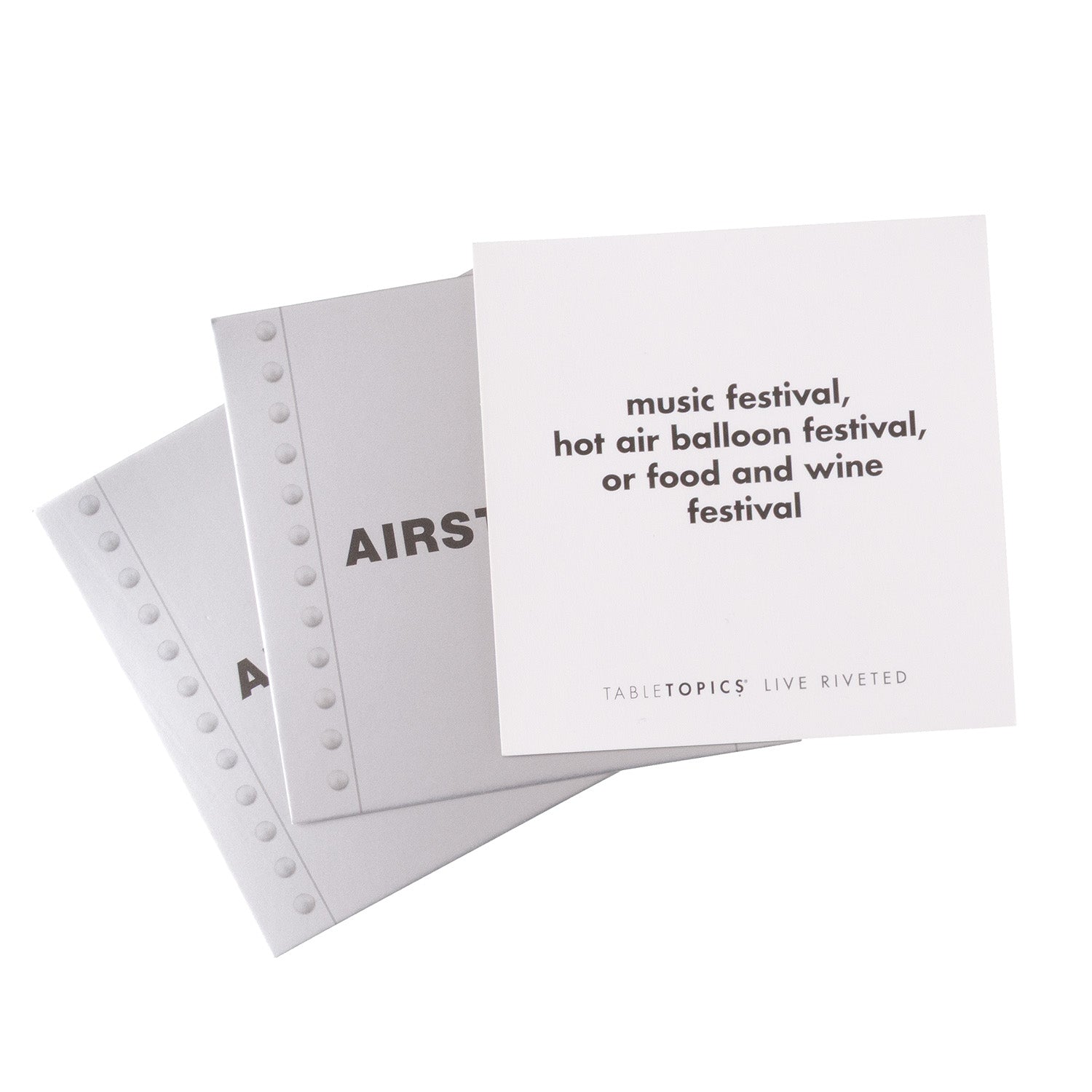 TableTopics Airstream Live Riveted Conversation Cards fanned out with question - Music festival, hot air balloon festival, or food and wine festival?
