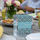 TableTopics Dinner Party conversation card box on a table at an outdoor party.