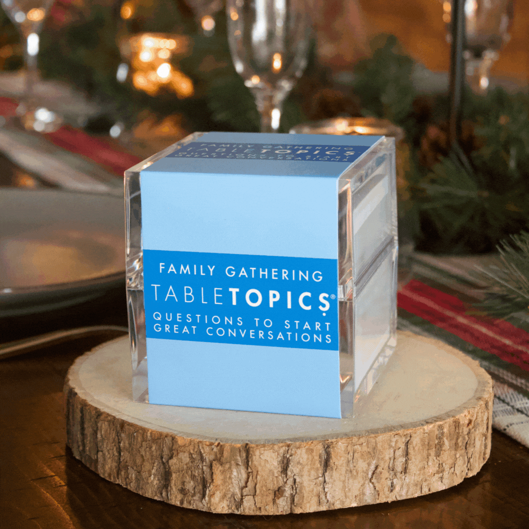 TableTopics Family Gathering conversation card set on table decorated for holidays. Closed, open, pulling card out, and showing card up close.