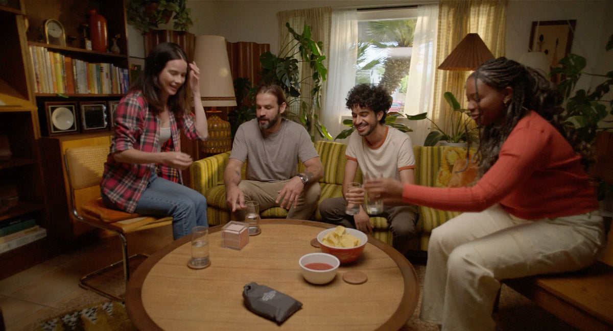 Friends playing TableTopics Original in living room