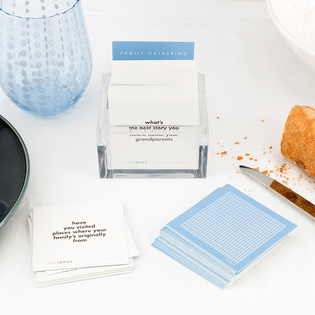 TableTopics Family Gathering on a dinner table after the meal. Some of the played cards are laid out.