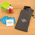 TableTopics Family Conversation Pack with some cards in front and a Phone Away Bag with phones sticking out of the top