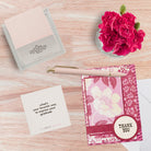 TableTopics Gratitude conversation card set open on a table next to a thank you card and a question card that says, "What's your favorite way to express your gratitude?"