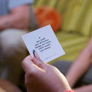 Hand holding TableTopics Original card with the question, "If you could give all human beings one virtue, which would you choose?"
