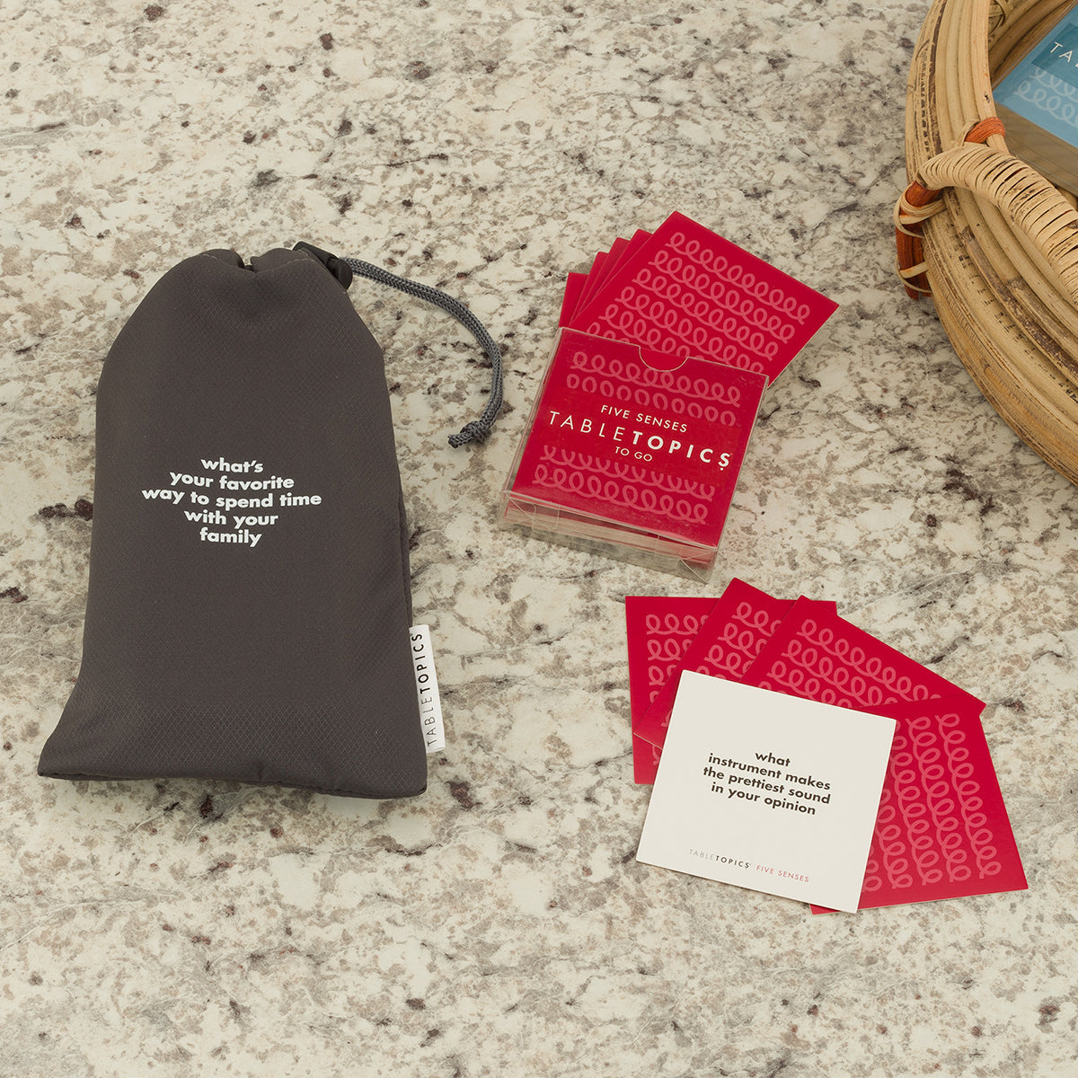 TableTopics Phone Away Bag filled with phones on a table with a TableTopics Five Senses