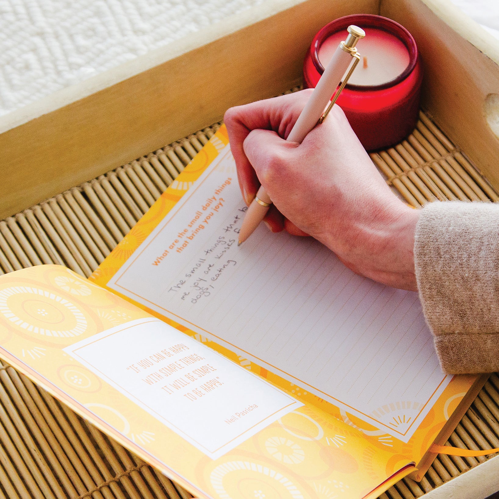 Woman writing in TableTopics Happiness Prompted Journal