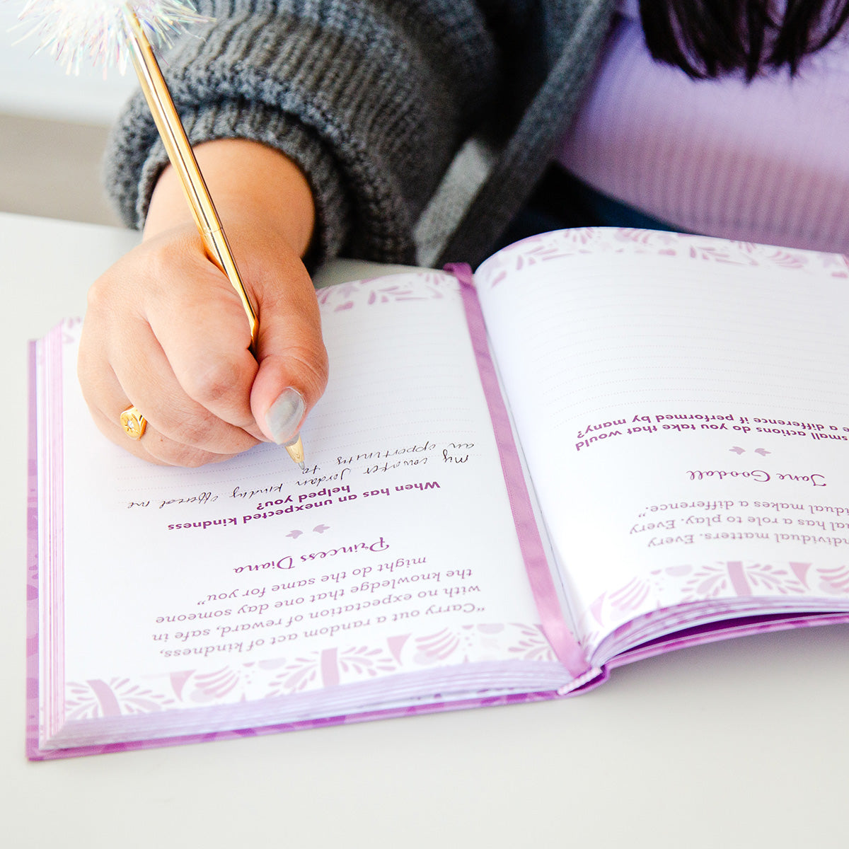 Woman writing in TableTopics Inspiration Prompted Journal