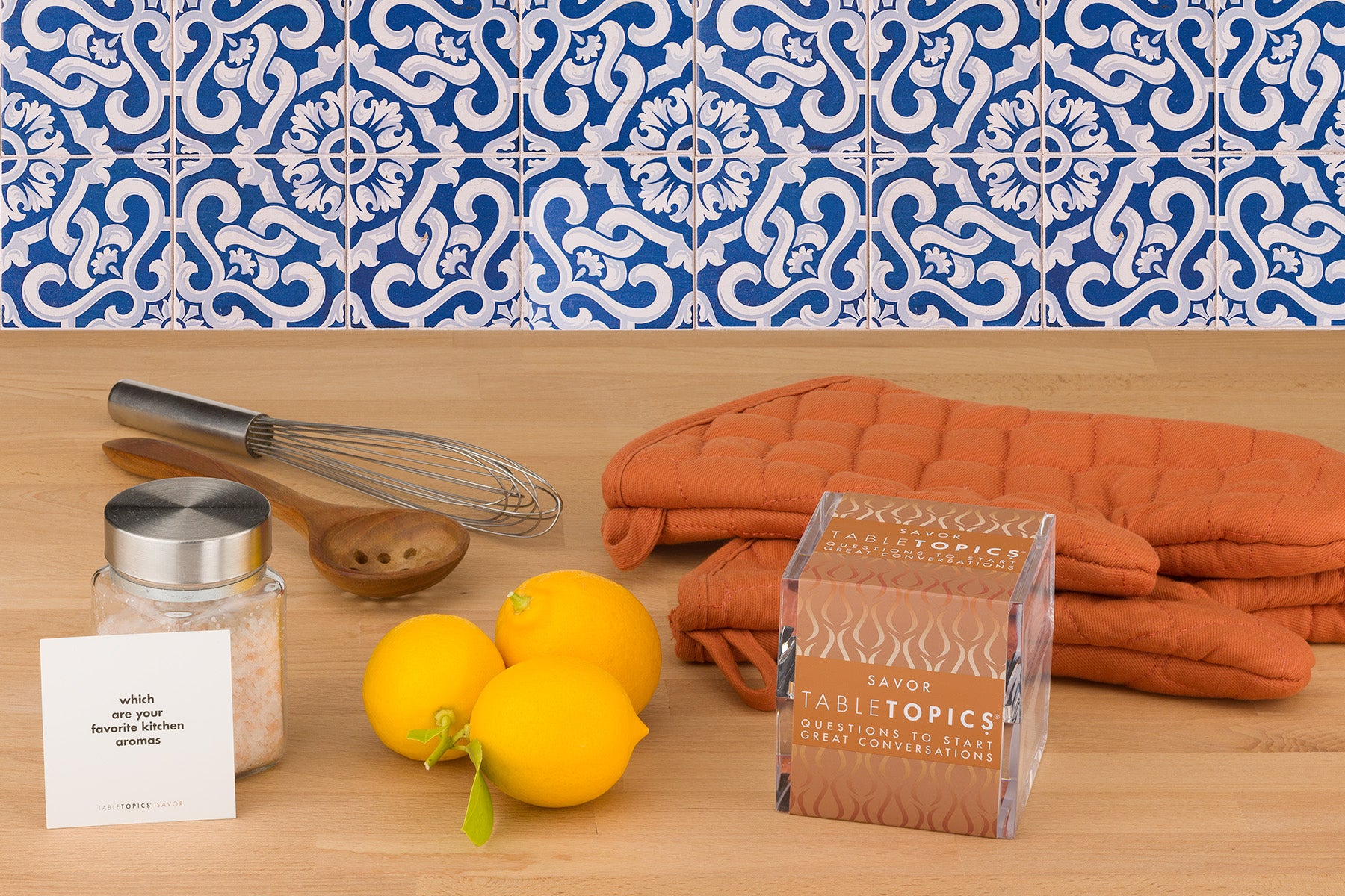 TableTopics Savor on a kitchen counter next to lemons with a card that says - which are your favorite kitchen aromas?