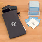 TableTopics Phone Away Bag with "what's your favorite way to spend time with your family" printed on the front. It is sitting on a table next to TableTopics Family Gathering cards.