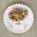 TableTopics Original conversation card on a plate with ginger. The question is, "What's the strangest thing you've ever eaten?"