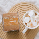 TableTopics Savor conversation starter setr next to a cup of cocoa with huge marshmallows