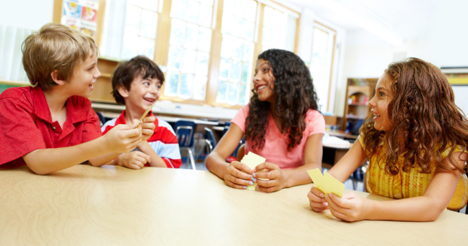 Four Kids Playing TableTopics in their Classroom