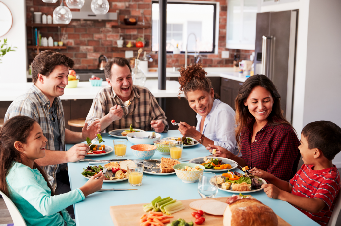 Family of six eating dinner and talking