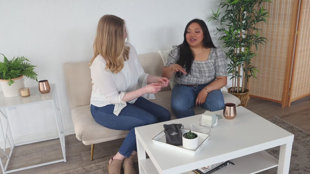 Two women on a couch playing TableTopics