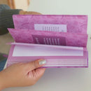 Hands flipping through the pages of the Inspiration Prompted Journal