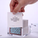Hand pulling out TableTopics Dinner Party cards from the container and showing the questions