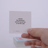 Hand pulling out TableTopics Not a Chance conversation cards from the container and showing the questions